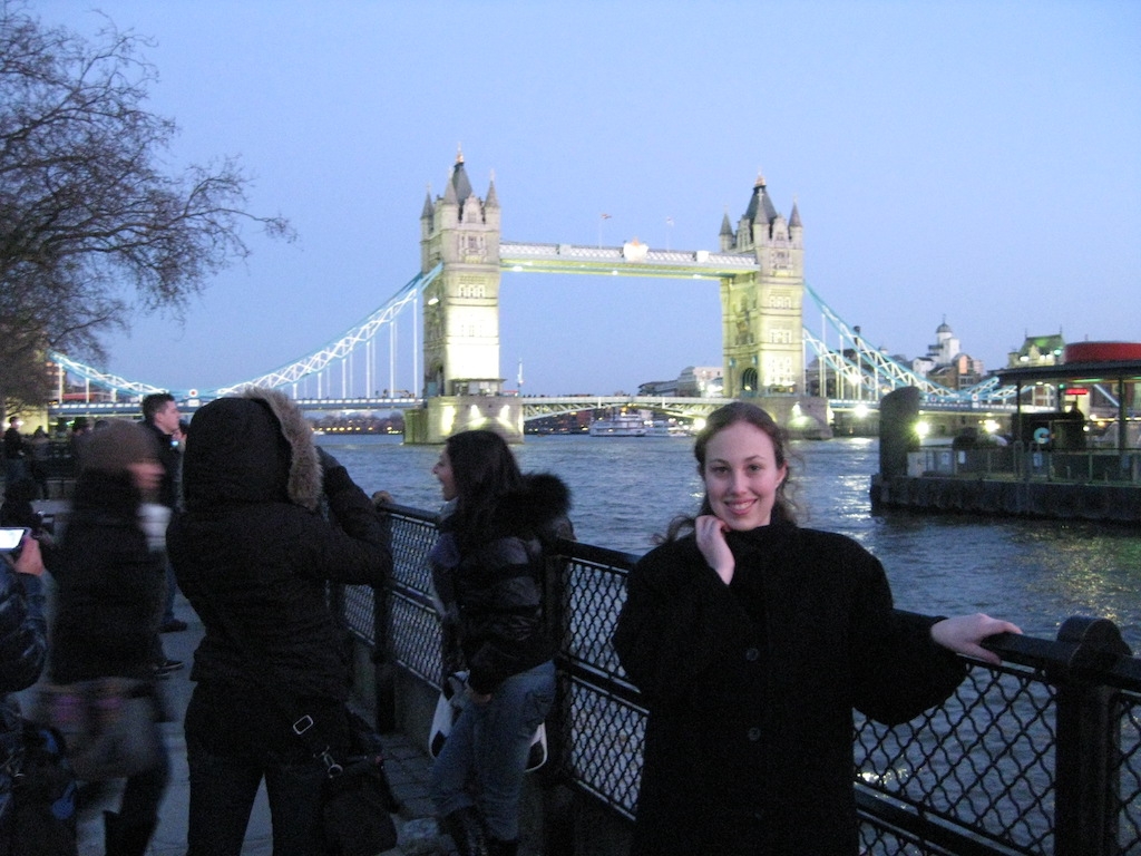 Jacquelyn Greenspan standing in front of the Tower of London bridge at night